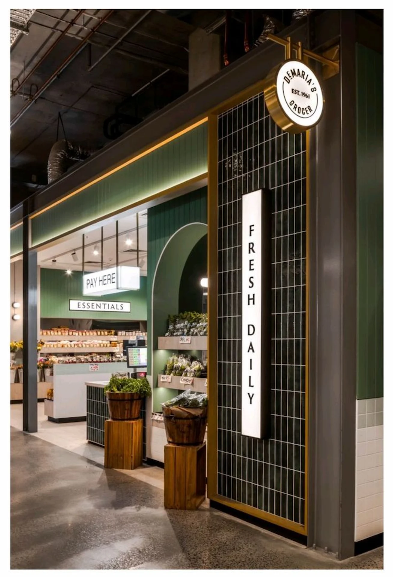 Branding by Spherical 11 Modern grocery market entrance with green tiles, fresh produce displays, and illuminated “Fresh Daily” signage.