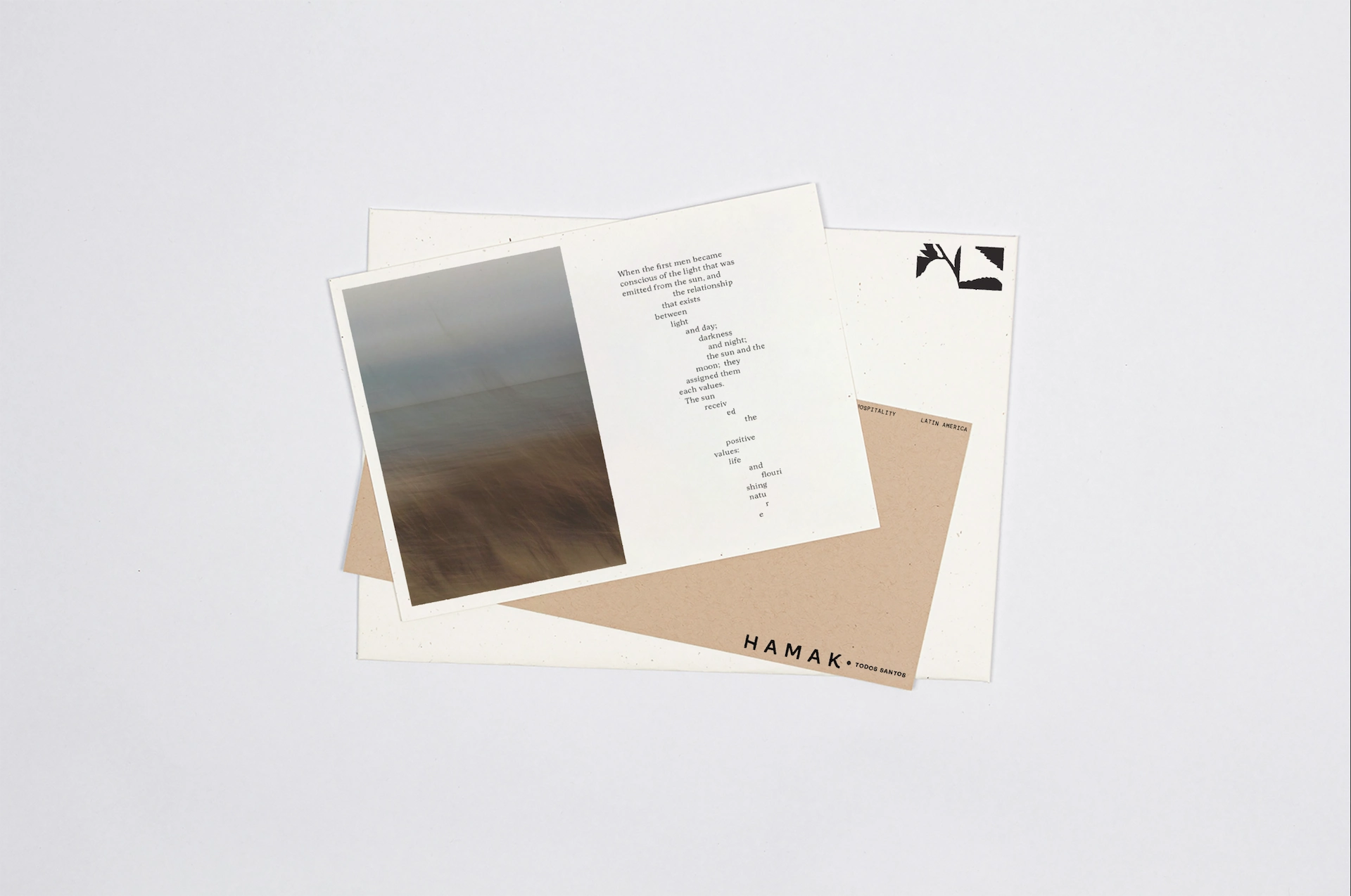 Hamak 5 Overlapping promotional cards on light surface; top card shows beach photo with poetic text, bottom card reads “HAMAK * TODOS SANTOS.”