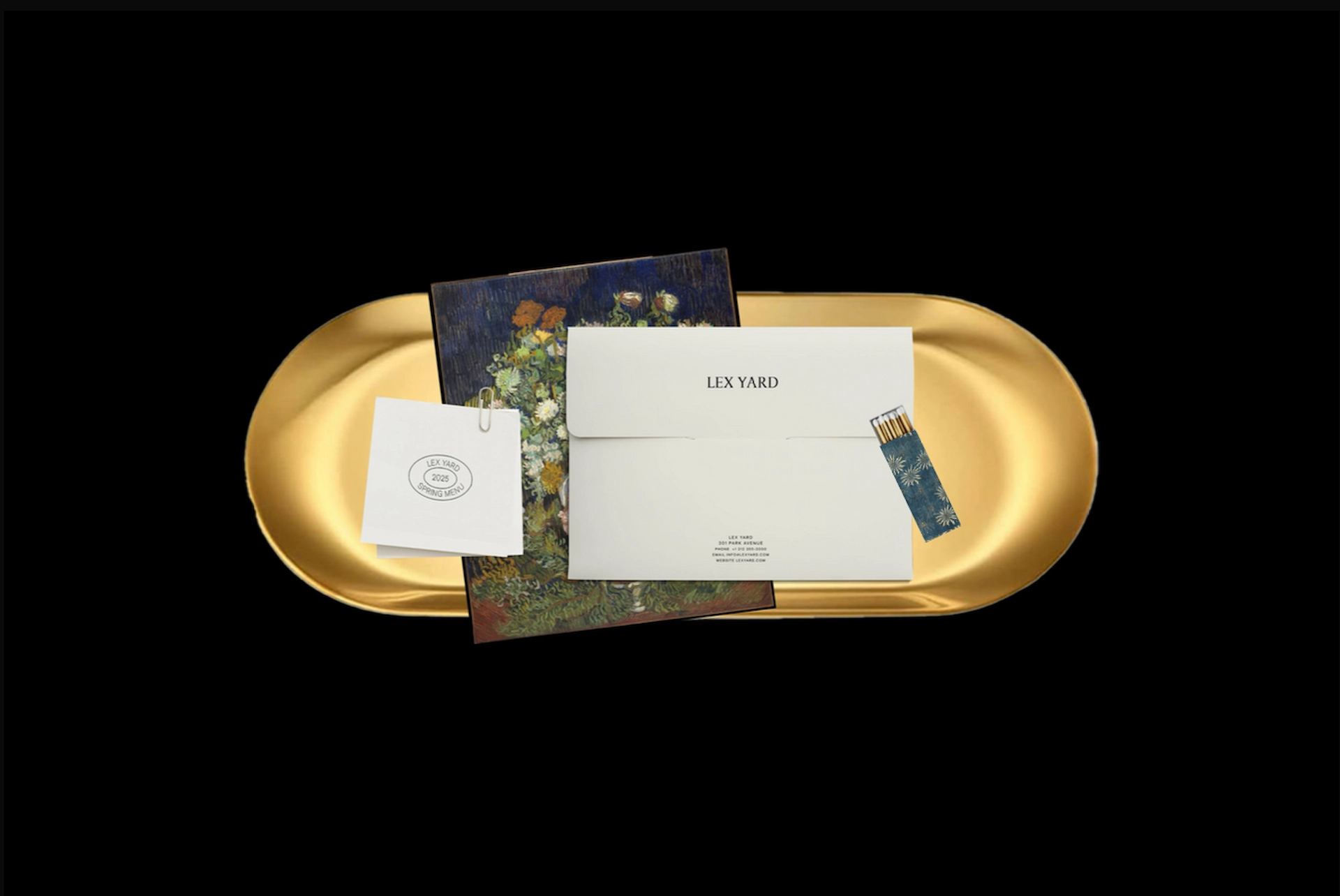 Flat lay of LEX YARD stationery on gold tray, including envelope, floral card, and spring menu.