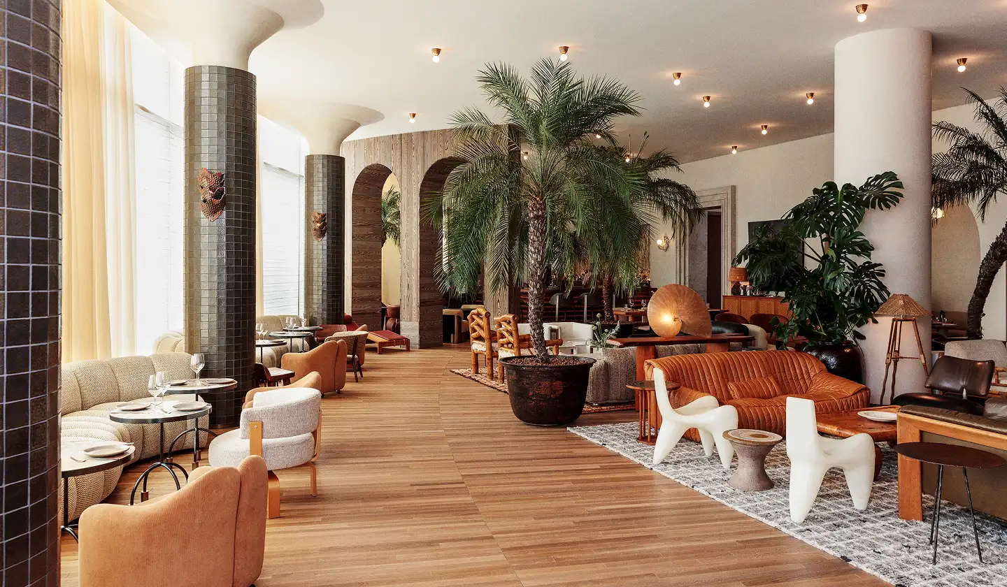 Stylish lounge interior with palm trees, warm lighting, and modern seating throughout.